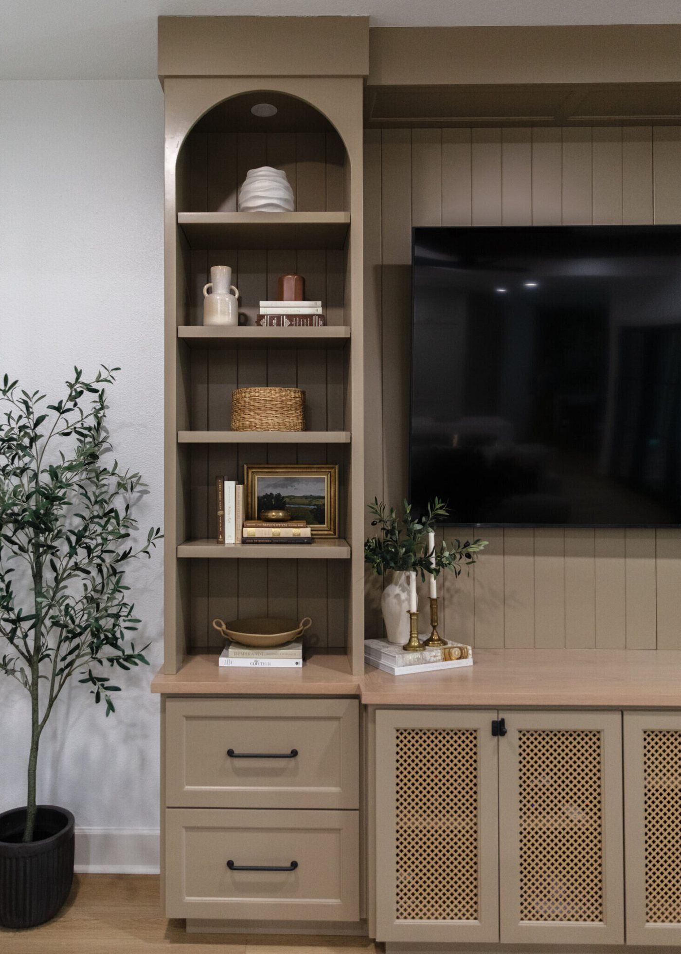 Media wall with arched niches, white oak shelving and cane cabinet doors in the Alexandria project by Jennifer Kizzee Design
