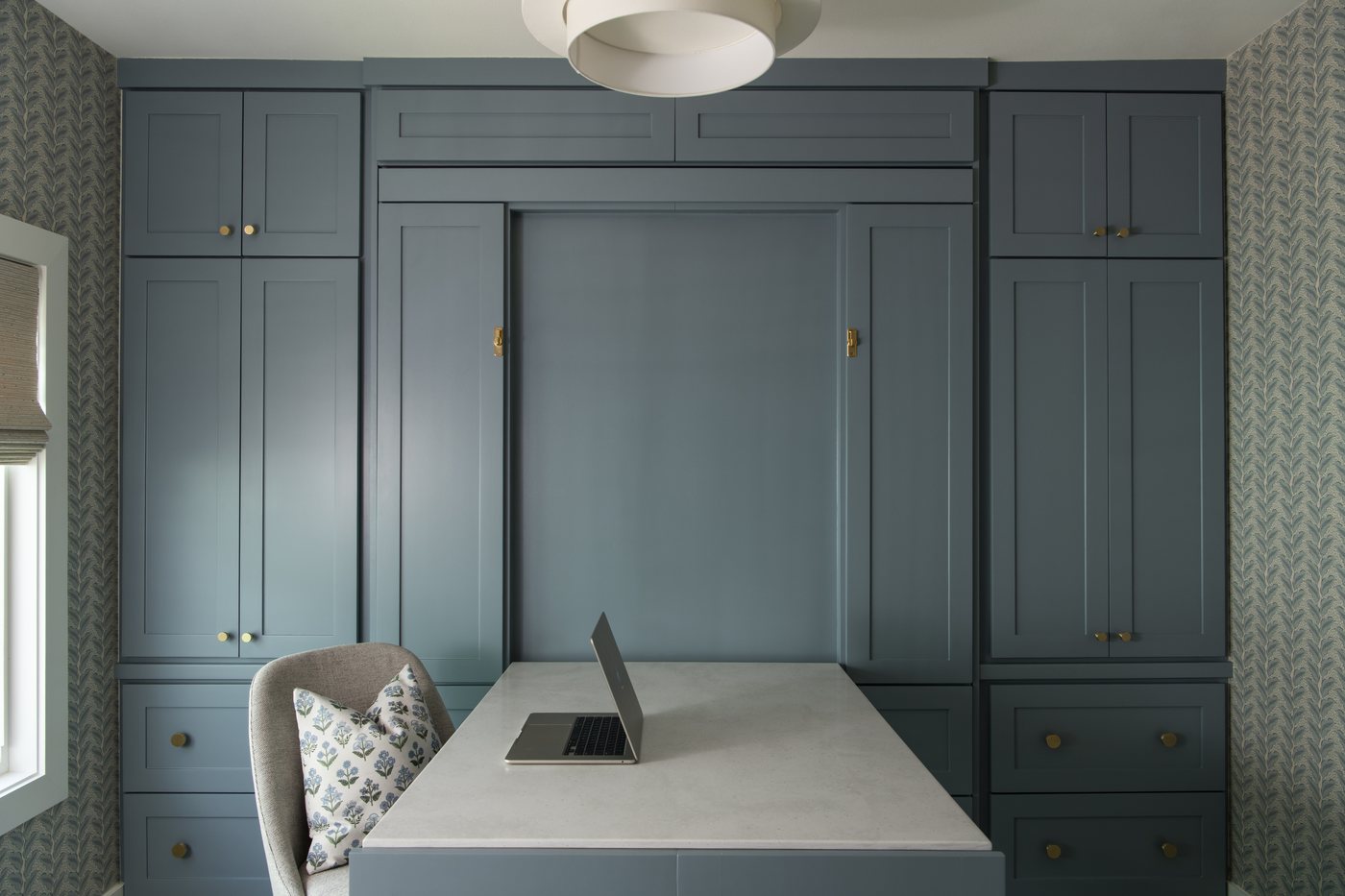 Blue grey built in cabinetry in the bunk room with a fold down desk in the Bolivar Beach House project by Jennifer Kizzee Design