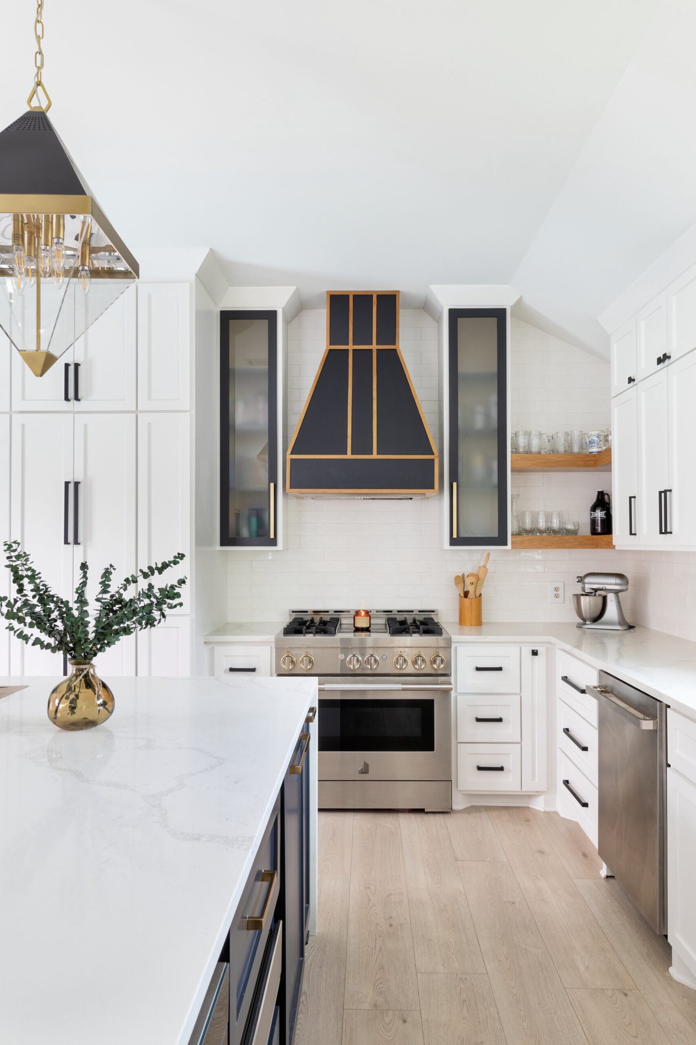 Kitchen seen from the dining side with the hood and pendants in line in the Branstetter Kitchen project by Jennifer Kizzee Design