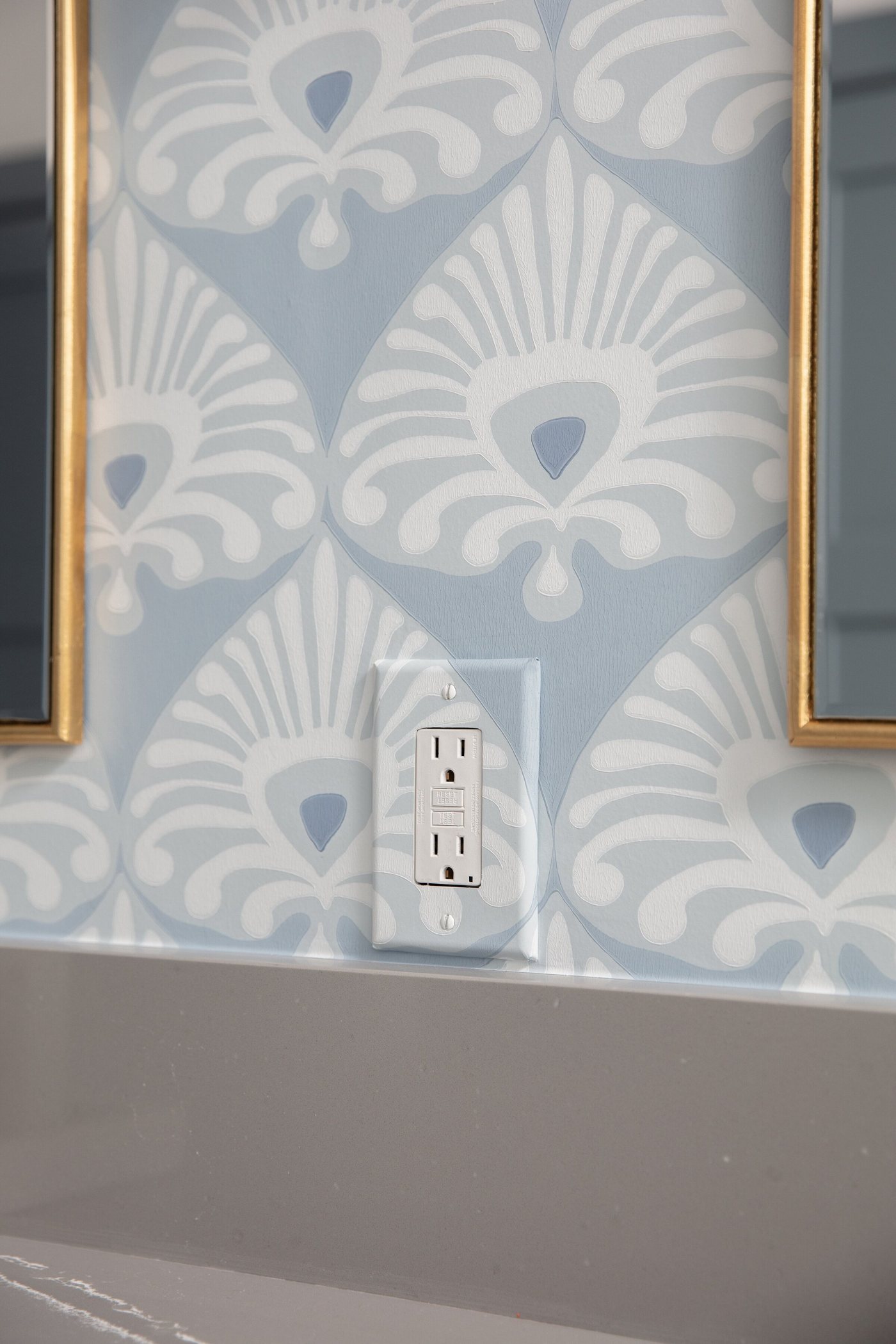 Close view of the blue and white wallpaper pattern beside the tub in the Crescent Bath project by Jennifer Kizzee Design