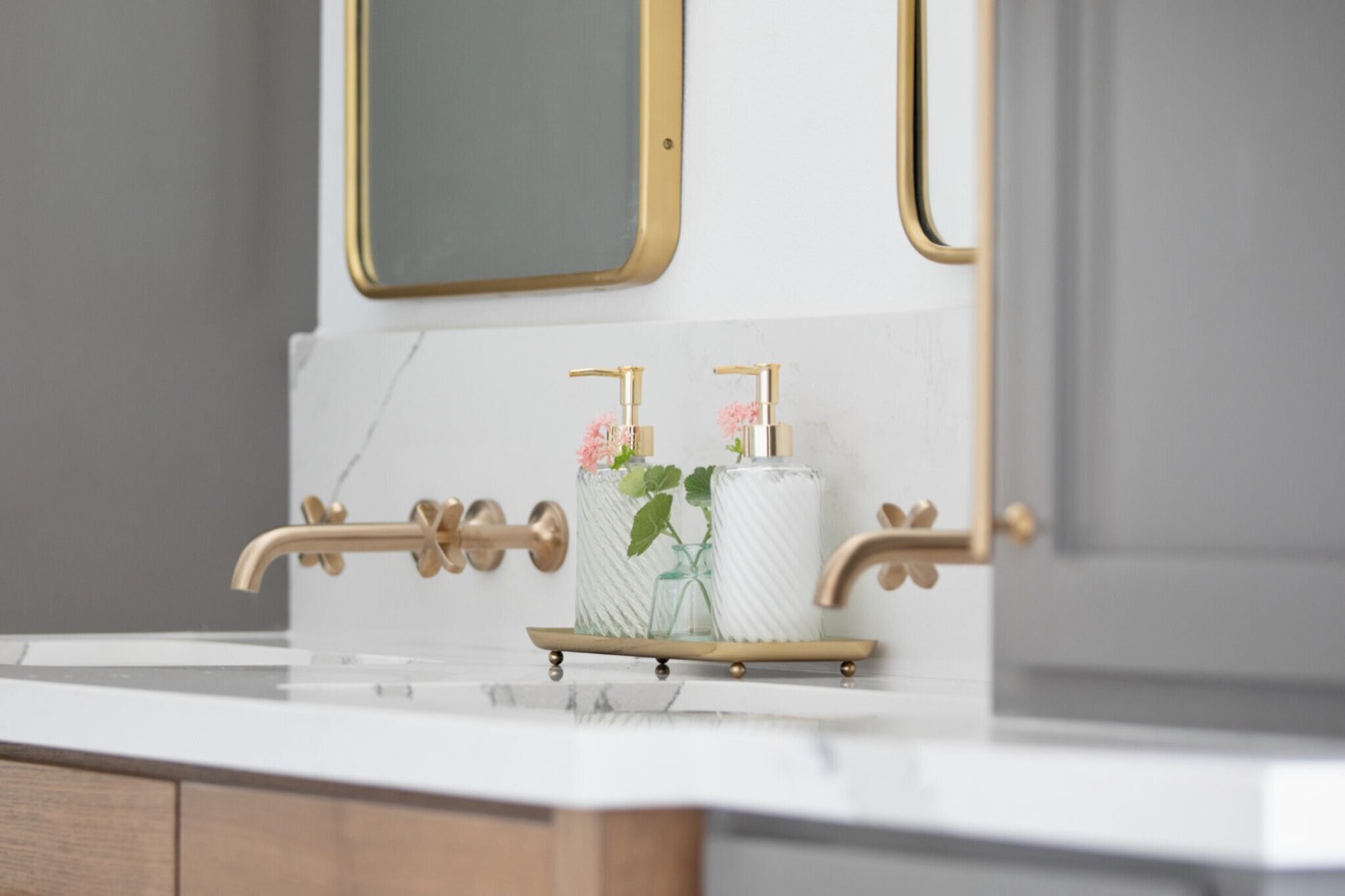 White and gray marble geometric floor mosaic at the base of the freestanding tub in the Evergreen Suite Bathroom project by Jennifer Kizzee Design