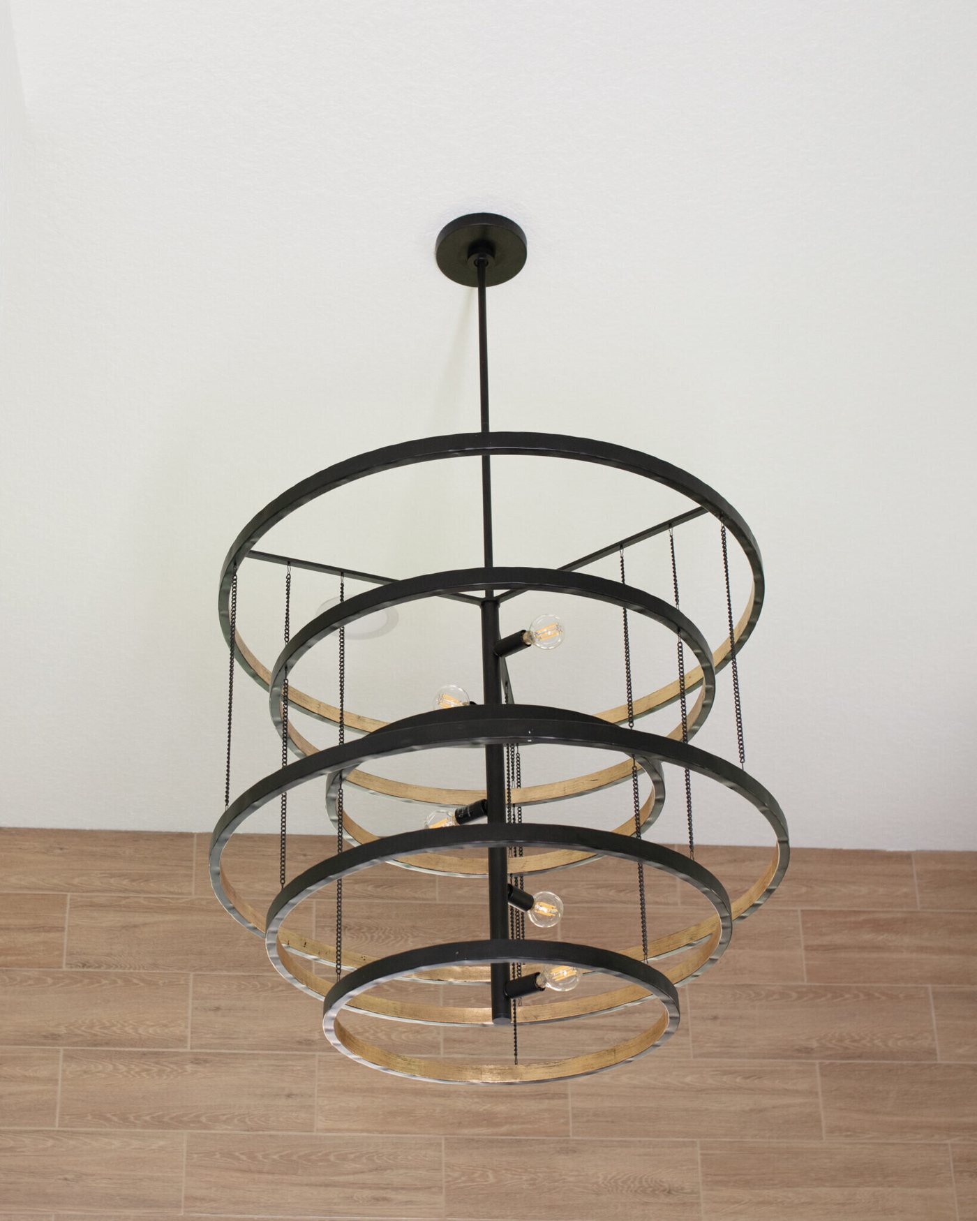 Black and brass orb chandelier hung in the bath in the Fox Run Modern Bath project by Jennifer Kizzee Design