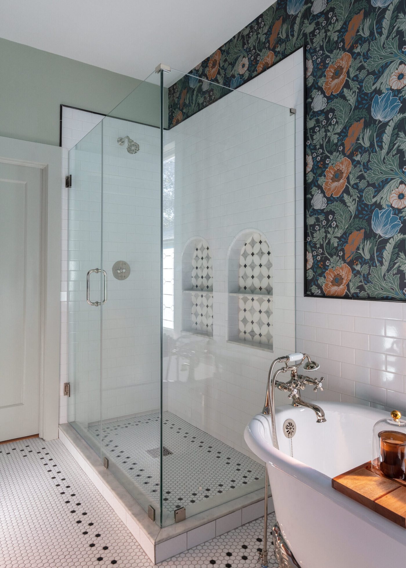 Glass shower enclosure with nickel fittings beside the clawfoot tub in the Heights Primary Bath project by Jennifer Kizzee Design