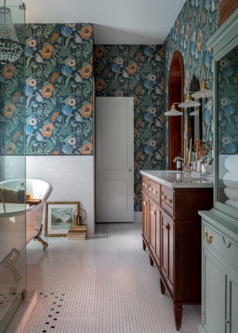 Primary bath with floral wallpaper, a clawfoot tub and a hex mosaic floor in the Heights Primary Bath project by Jennifer Kizzee Design