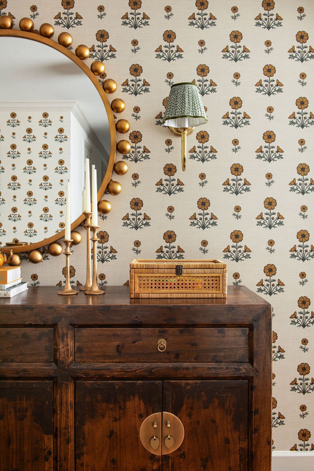 Gold beaded mirror against block print wallpaper above the chest in the Holcombe Condo project by Jennifer Kizzee Design