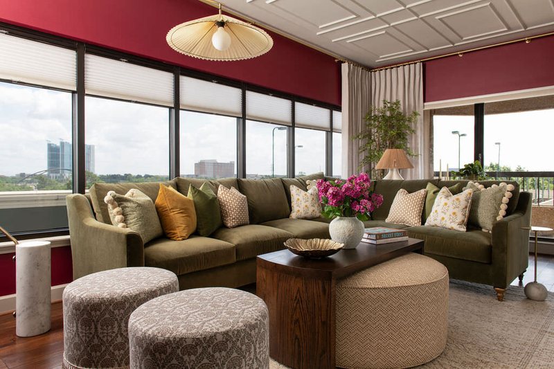 Living room in olive green with city views under a coffered ceiling in the Holcombe Condo project by Jennifer Kizzee Design
