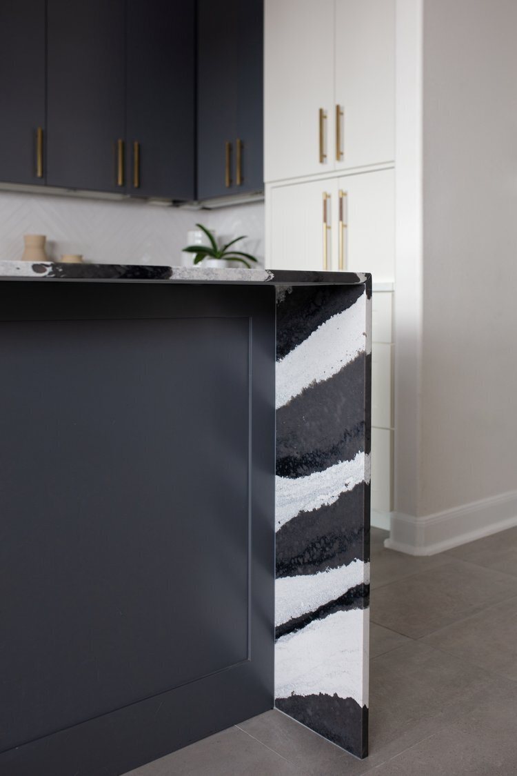 Reclaimed wood slab finishing the end of the charcoal island in the Longwood project by Jennifer Kizzee Design