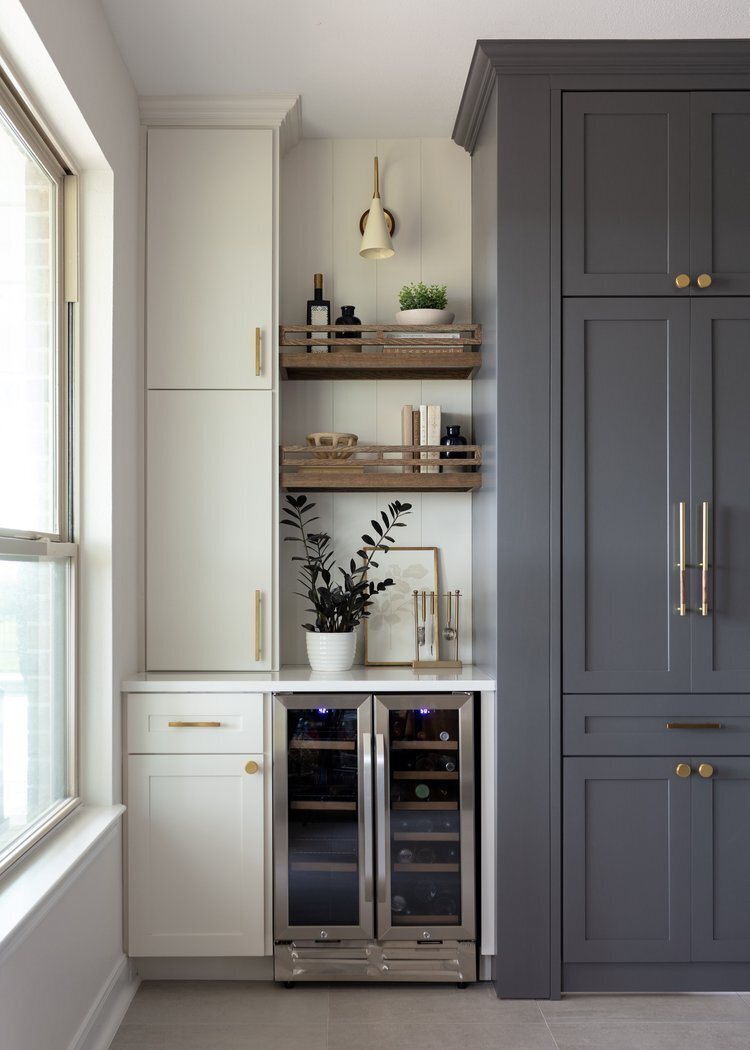 Tall cabinetry with open wood shelves and glass front beverage refrigerators in the Longwood project by Jennifer Kizzee Design