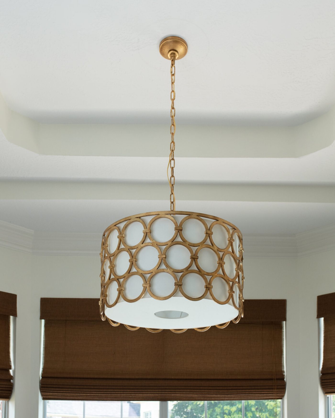 Woven drum pendant hung over the sitting area in the Marrelli Project project by Jennifer Kizzee Design