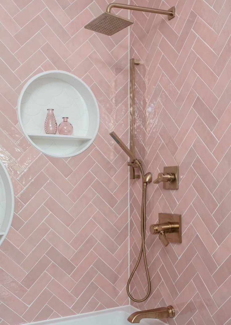 Pink zellige shower with round niches and brass fittings in the Pine Lodge project by Jennifer Kizzee Design