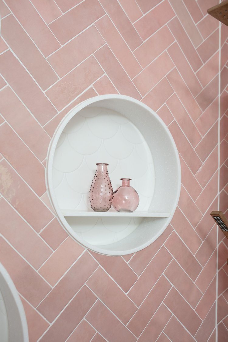 Round niche set into the pink zellige tile holding two vases in the Pine Lodge project by Jennifer Kizzee Design