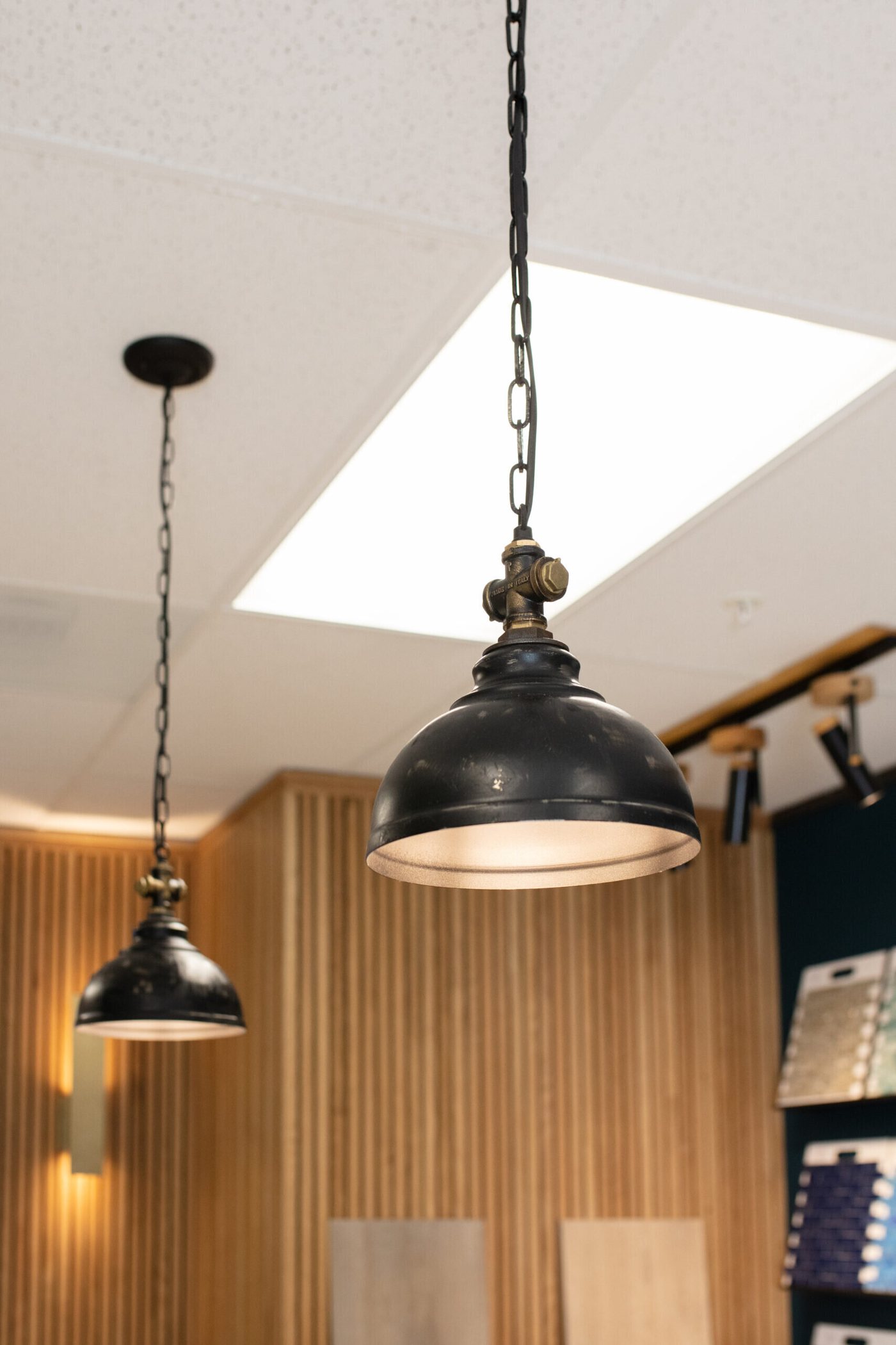 Industrial dome pendants hung over the selection table in the Pool Envy project by Jennifer Kizzee Design