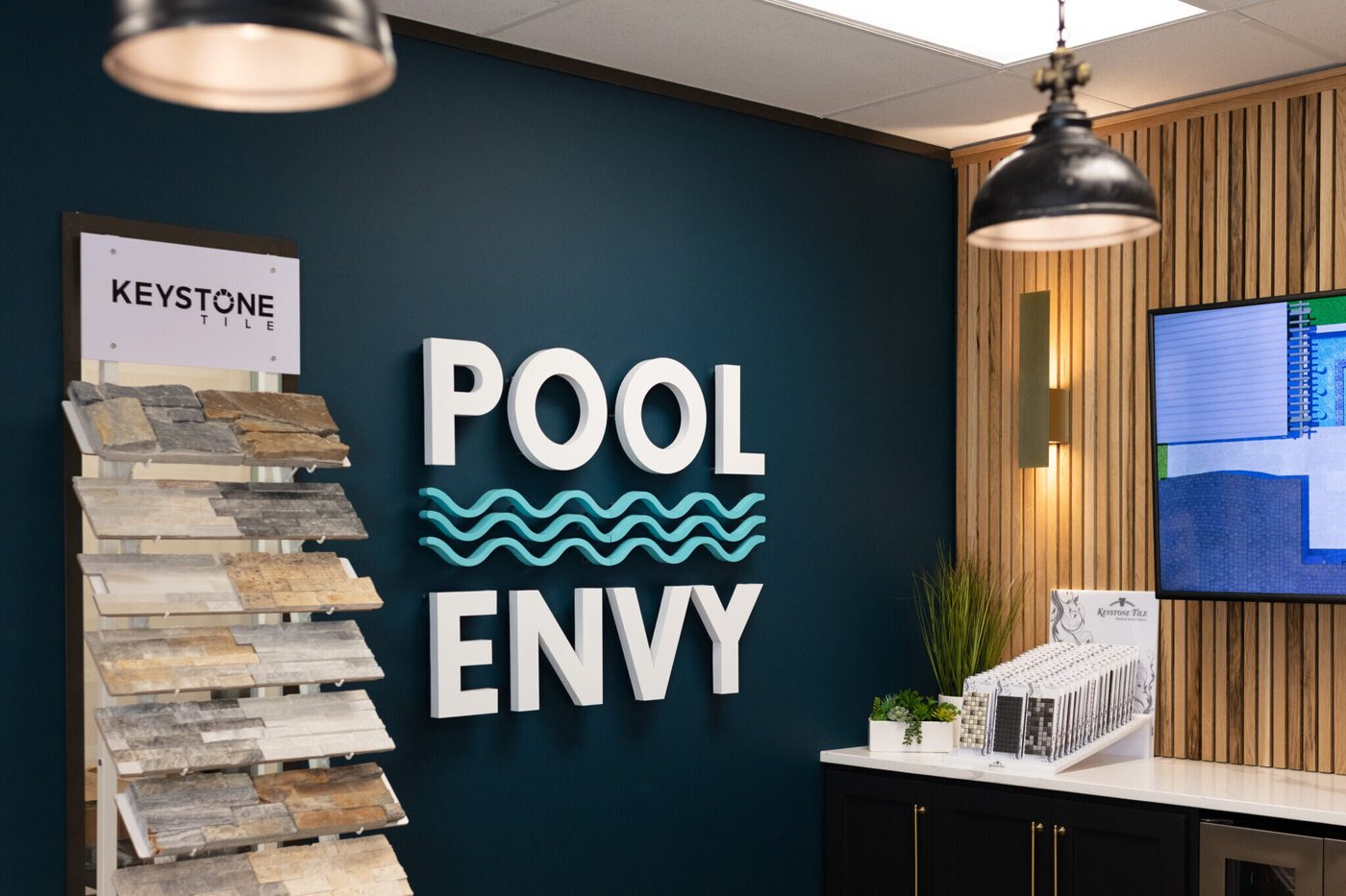 Showroom entry with the sample display and beverage refrigerator in the Pool Envy project by Jennifer Kizzee Design