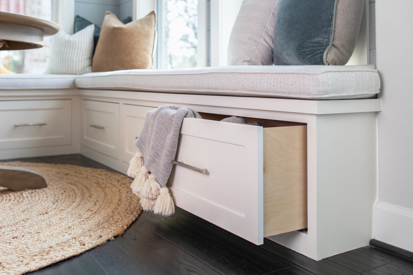 Storage drawer pulled open beneath the built-in window bench cushion in the Silver Moon project by Jennifer Kizzee Design