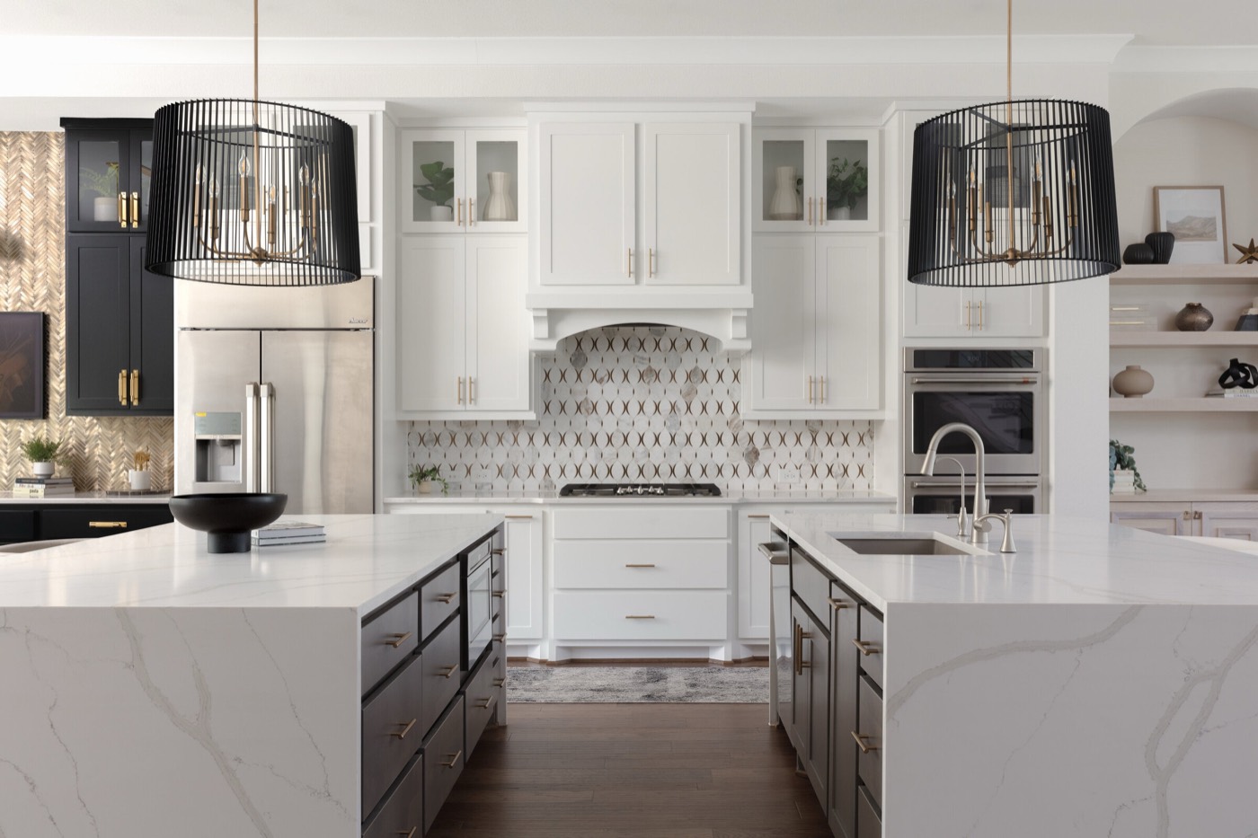 Kitchen with twin white quartz waterfall islands under paired black slat drum pendants in the Vue Point project by Jennifer Kizzee Design